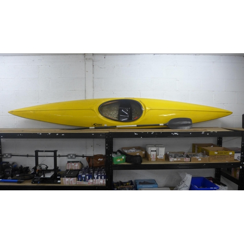 2064 - A Fiberglass Kiwi Slalom 400 canoe with paddle and a plastic safety helmet