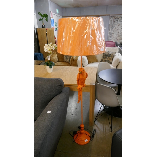 1347 - An orange floor standing lamp in the form of a parrot