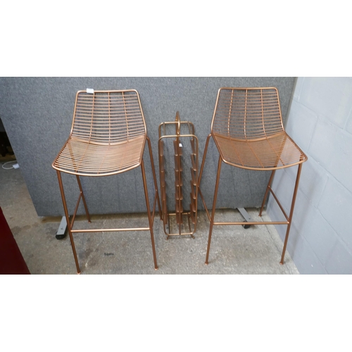 1420 - A pair of copper coloured bar stools and a wine rack