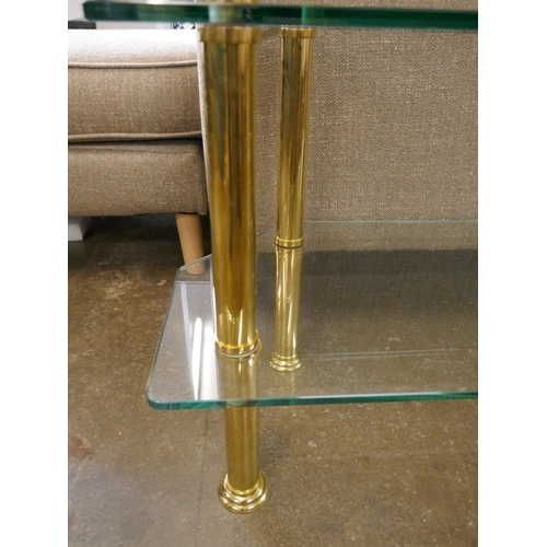1460 - A two tier corner table, toughened glass and solid brass legs