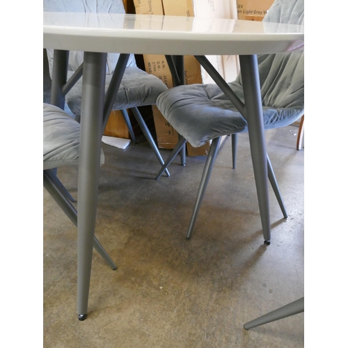 1490 - A Logan circular dining table and four Aran grey velvet chairs