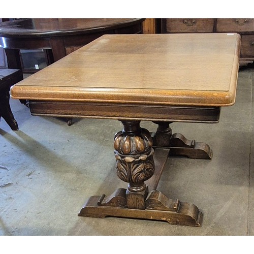 227 - An early 20th Century carved oak extending dining table