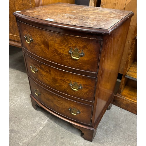 149 - A small George III style walnut bow front chest of drawers