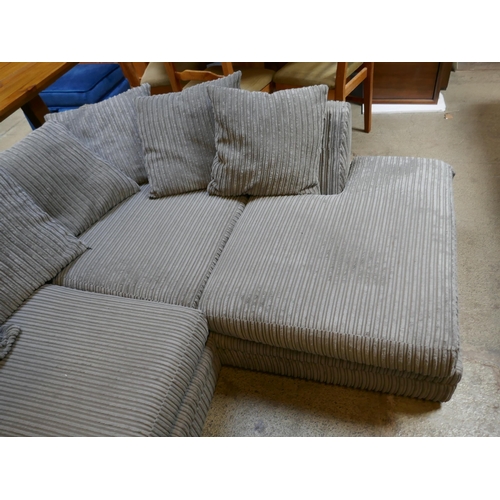 1544 - A grey cord corner sofa and a black footstool