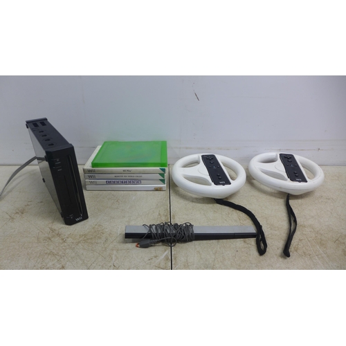 2095 - A black Nintendo Wii console with 2 wireless controllers, 2 steering wheel controller adapters and a... 