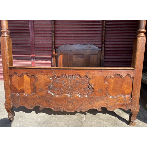 96 - An 18th Century French provincial carved fruitwood full tester bed
