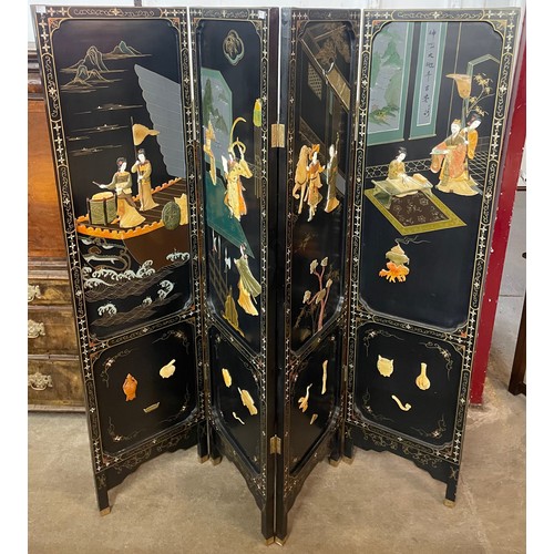 107 - A Chinese black lacquered chinoiserie folding dressing screen