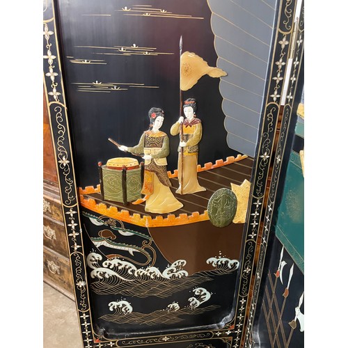 107 - A Chinese black lacquered chinoiserie folding dressing screen