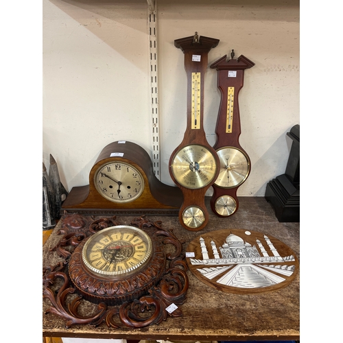 348 - Three aneroid barometers, a mantle clock and in Indian hardwood and faux ivory wall plaque, depictin... 