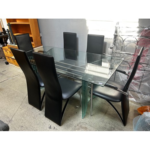 1536 - A  large glass dining table with six black leather chairs