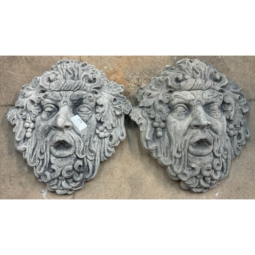 279 - A pair of concrete green men garden wall masks