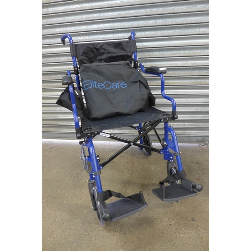 2265 - An Elite Care operator driven folding wheelchair with footrests and carry bag