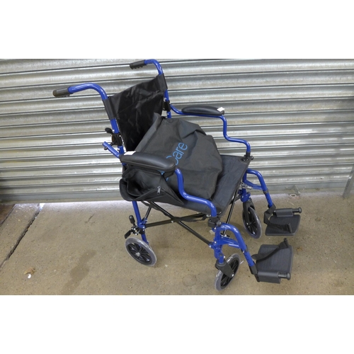 2265 - An Elite Care operator driven folding wheelchair with footrests and carry bag