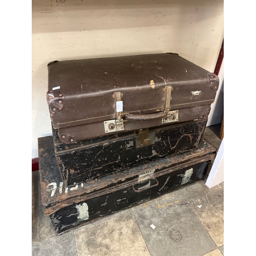 356 - Two metal trunks and a leather suitcase