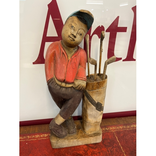377 - A carved wooden figure of a golfer