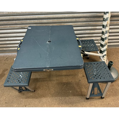 2391 - A foldaway compact picnic table with carry case and a parasol umbrella with parasol base