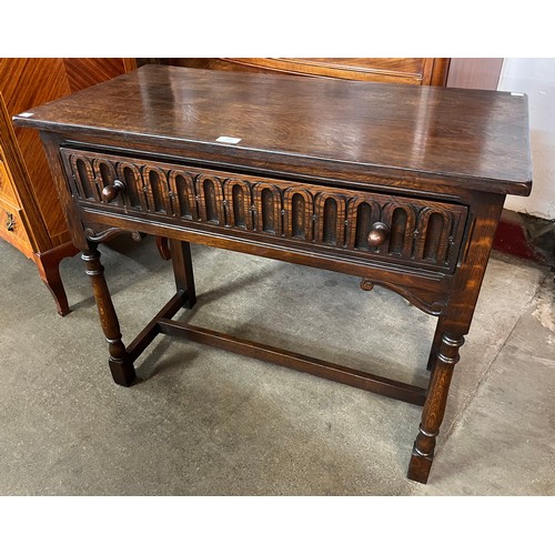 141 - A 17th Century style carved Ipswich oak single drawer side table