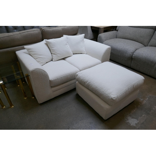 1605 - A white upholstered two seater sofa and footstool