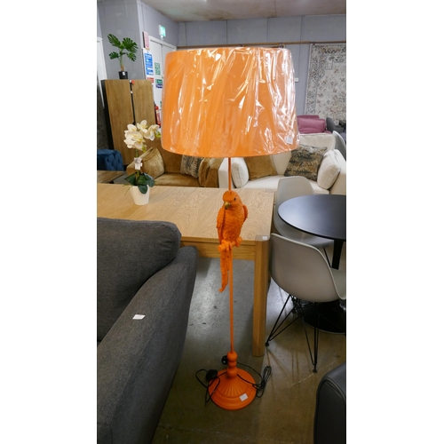 1366 - An orange floor standing lamp in the form of a parrot