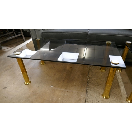 1434 - An oblong coffee table, toughened smoked glass with solid brass frame