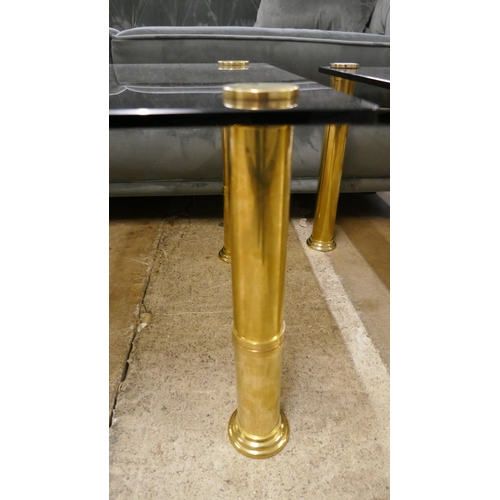 1434 - An oblong coffee table, toughened smoked glass with solid brass frame