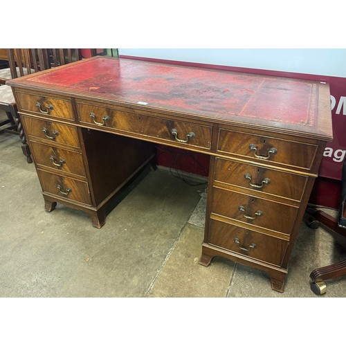 85 - A George III style mahogany and red leather topped pedestal desk