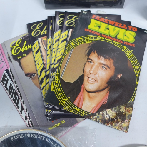 2030 - A crate of Elvis Presley collectibles including an ink wash set, prints, magazines, a watch in tin, ... 