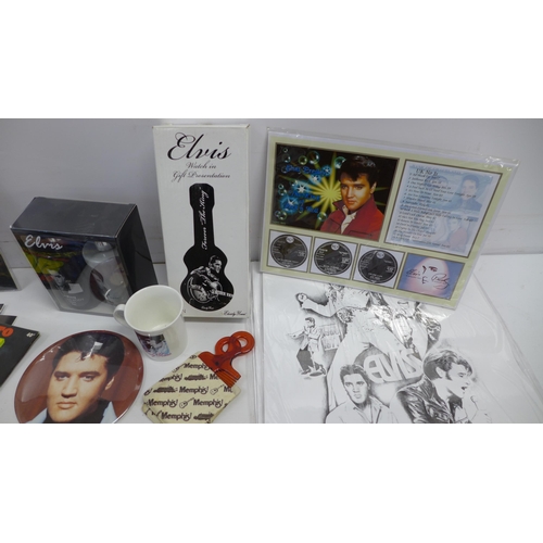 2030 - A crate of Elvis Presley collectibles including an ink wash set, prints, magazines, a watch in tin, ... 