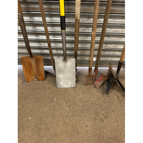 2165 - A quantity of garden tools including  forks, spades, plough, rakes, hoes etc.