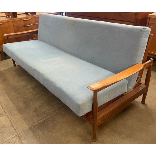 17 - A Guy Rogers teak and blue fabric upholstered three piece Manhattan lounge suite, comprising; settee... 