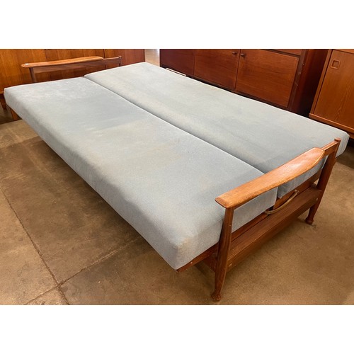 17 - A Guy Rogers teak and blue fabric upholstered three piece Manhattan lounge suite, comprising; settee... 