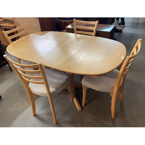 35 - An Ercol ash extending dining table and four chairs