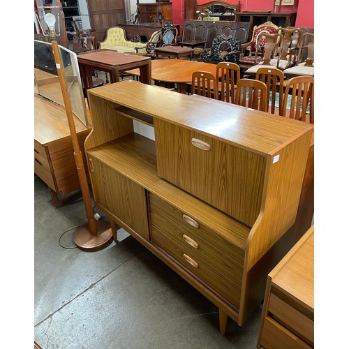 75 - A teak effect highboard and a beech standard lamp