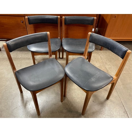 76 - A set of four teak and black vinyl dining chairs