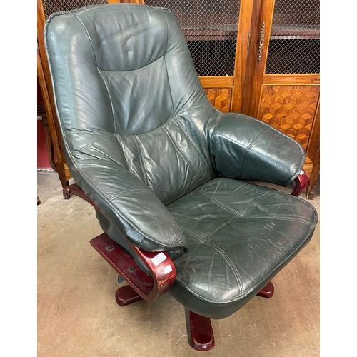 79 - A green leather reclining swivel armchair