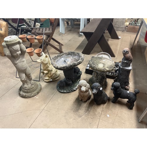 266 - Assorted concrete animal figures and bird baths with plant pot rack