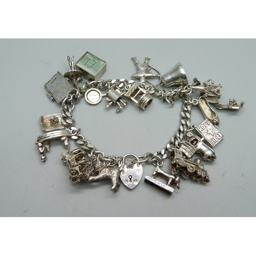 1009 - A silver charm bracelet, 64.5g