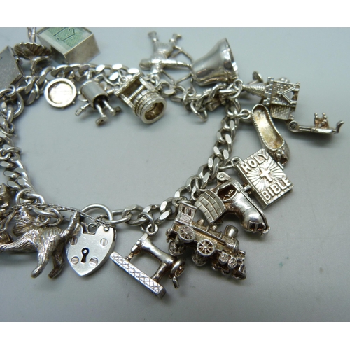 1009 - A silver charm bracelet, 64.5g