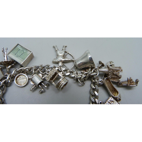 1009 - A silver charm bracelet, 64.5g