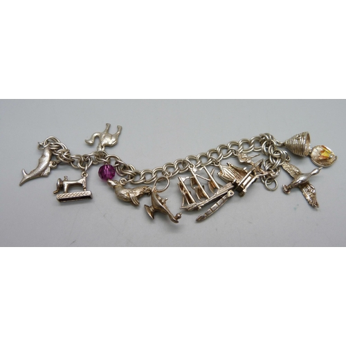 1010 - A silver charm bracelet, 40.1g