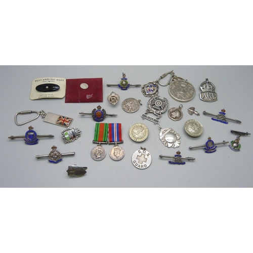 1070 - A collection of enamelled regimental brooches/badges, a silver ARP badge, fobs, medallions, a silver... 