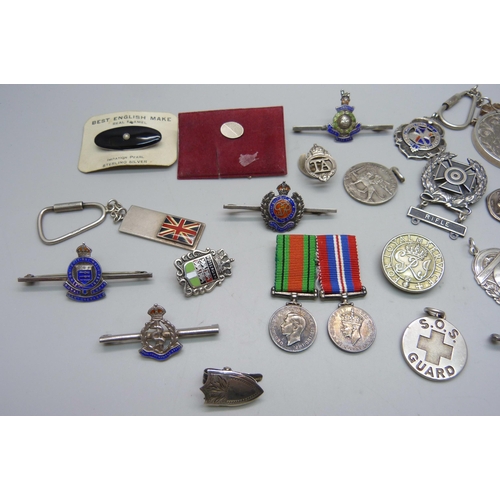 1070 - A collection of enamelled regimental brooches/badges, a silver ARP badge, fobs, medallions, a silver... 