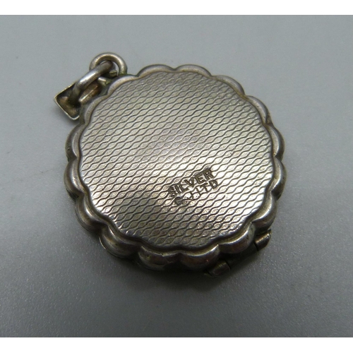 1076 - A silver Georg Jensen locket, a silver ring, and a plated bracelet with silver, white metal and plat... 