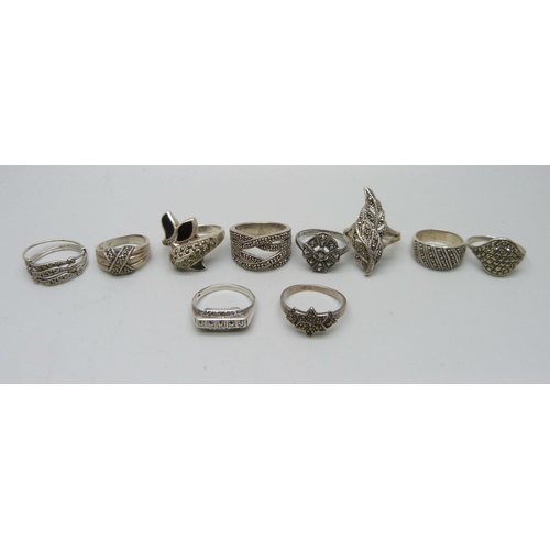 1100 - Nine silver and marcasite rings including a .800 example, together with an unmarked white metal ring... 