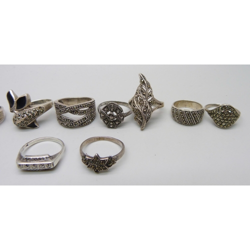 1100 - Nine silver and marcasite rings including a .800 example, together with an unmarked white metal ring... 