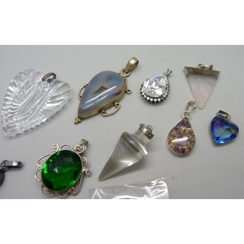 1109 - White metal mounted pendants including silver, and a single earring