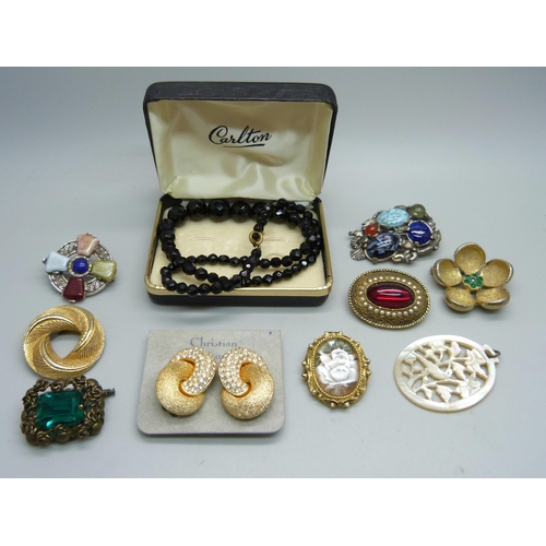 1130 - A pair of Christian Dior earrings, a French jet necklace, vintage brooches and a mother of pearl pen... 