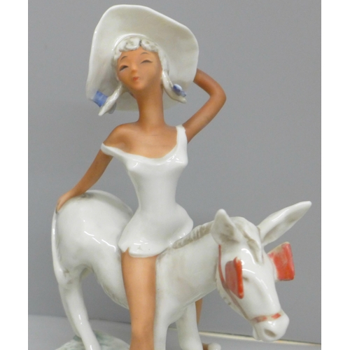 614 - A W. Goebel novelty hand painted figure, circa 1950s 'Lady Atop a Donkey' with red blinkers