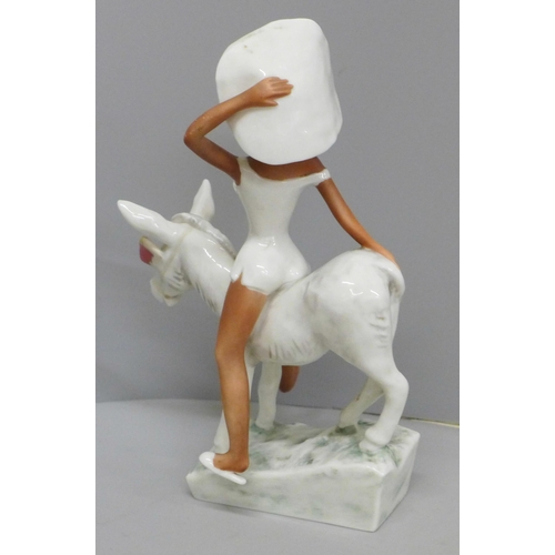 614 - A W. Goebel novelty hand painted figure, circa 1950s 'Lady Atop a Donkey' with red blinkers