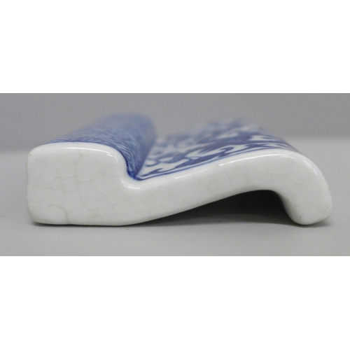 628 - A Chinese porcelain blue and white brush or pen rest, six character Kangxi mark